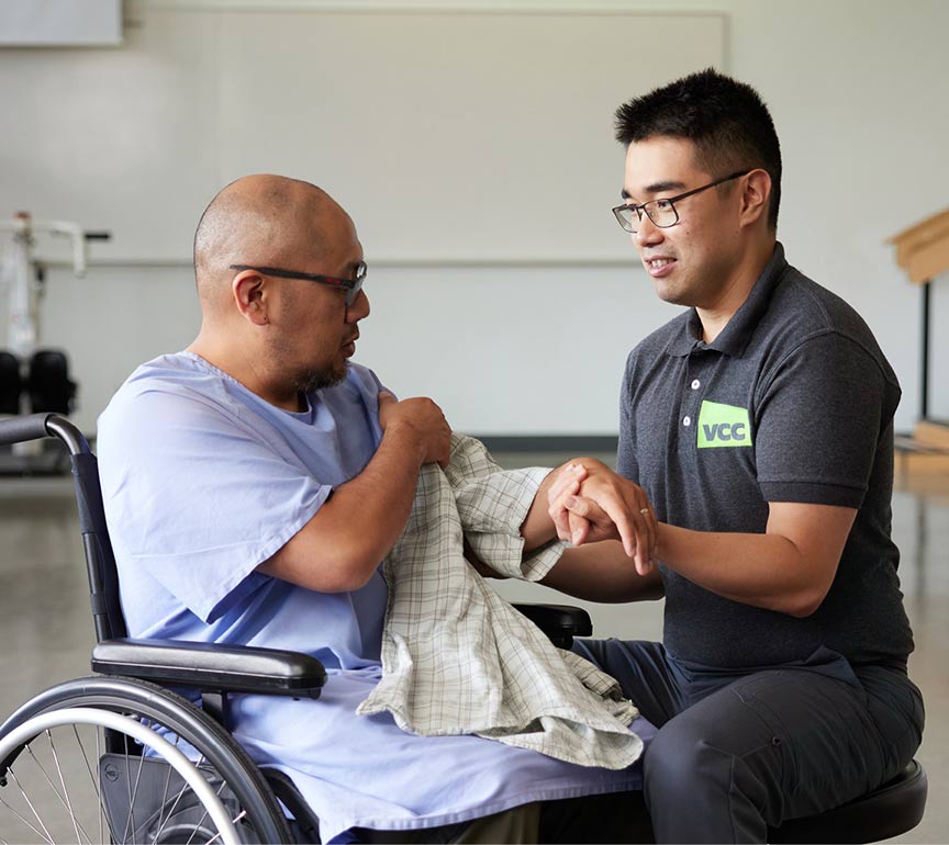 occupational physical therapist helping patient in a wheelchair