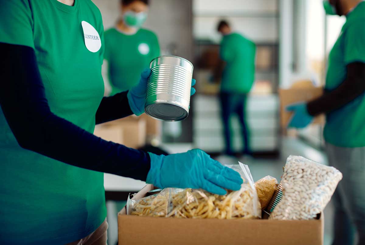 volunteers packing food in boxes for food bank donations