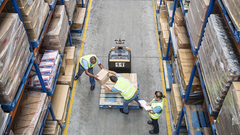 Men working in a warehouse handling boxes